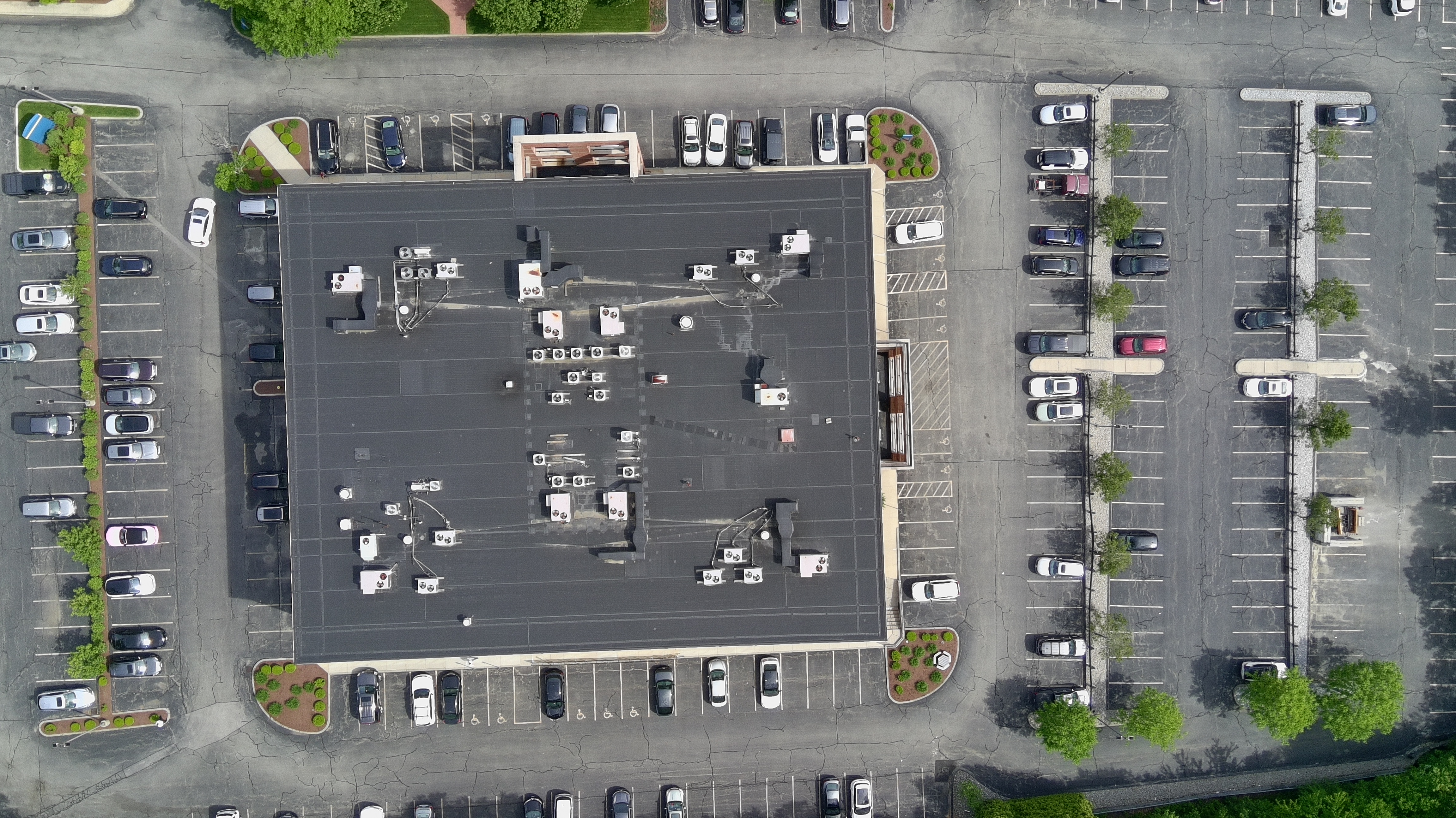 Aerial drone photo of a commercial roof and parking